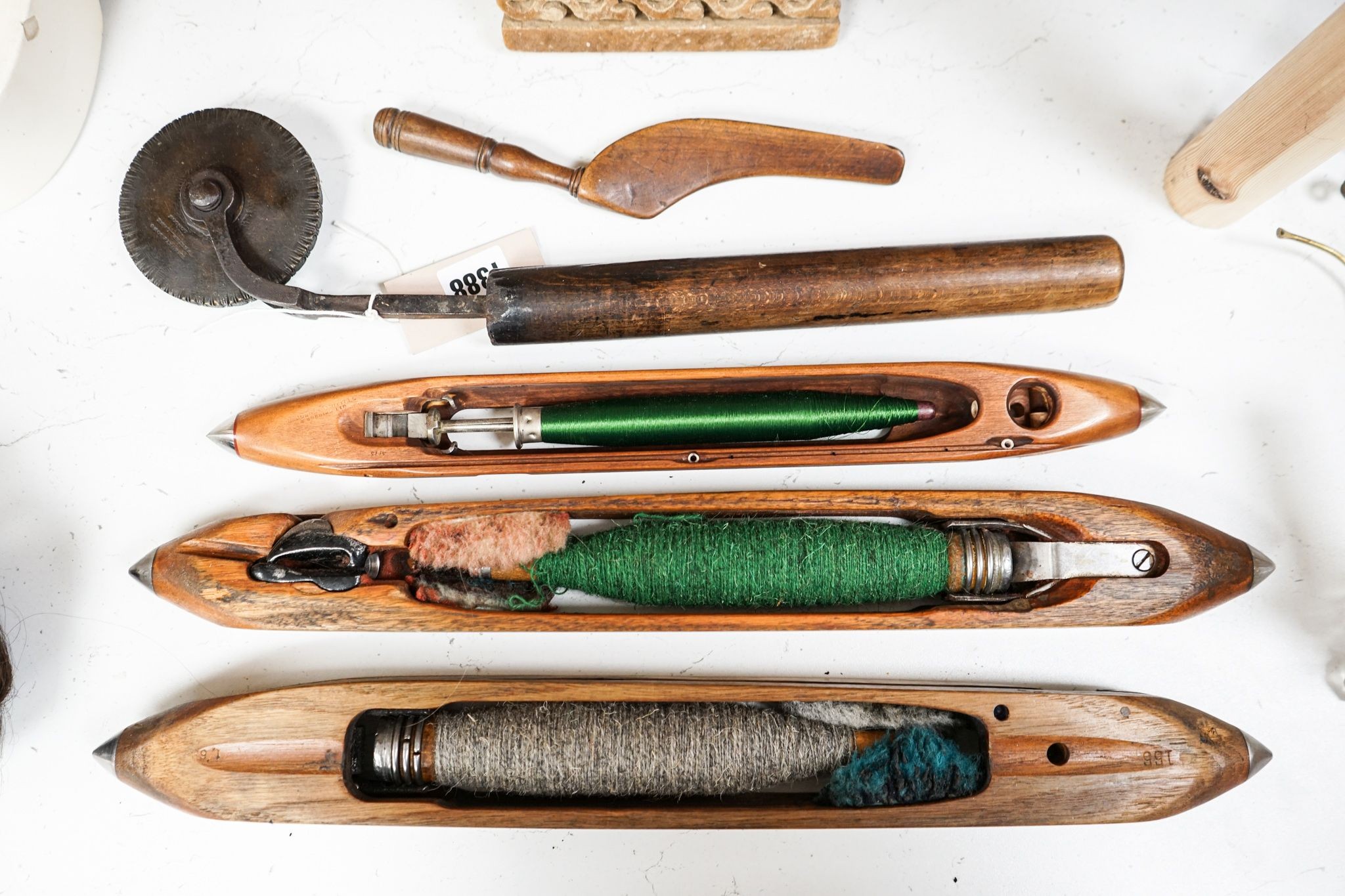 Three weaving shuttles, a crimper and two other items
